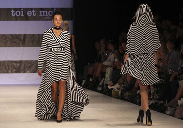 Models wearing outfits by designer Toi Et Moi Sydney walk along the runway during Fashion Week Australia in Sydney.