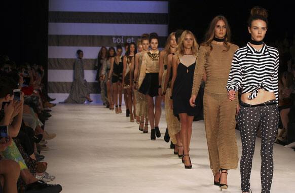 Models wearing outfits by designer Toi Et Moi Sydney walk along the runway during Fashion Week Australia in Sydney.