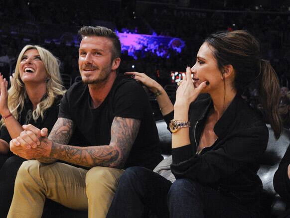 David Beckham and his wife Victoria watch the first half of a NBA first-round playoff basketball game between the Los Angeles Lakers and the Denver Nuggets in Los Angeles.