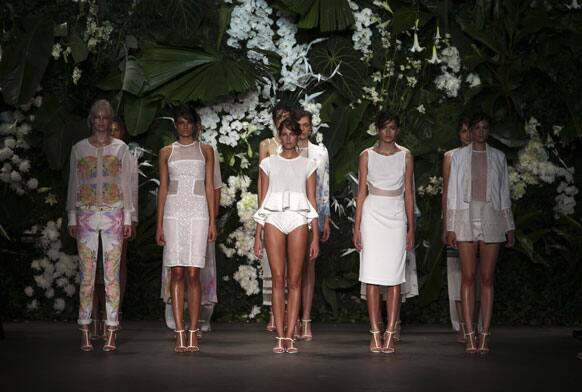 Model wearing designs from Bec & Bridge stand on the runway during Fashion Week Australia in Sydney.