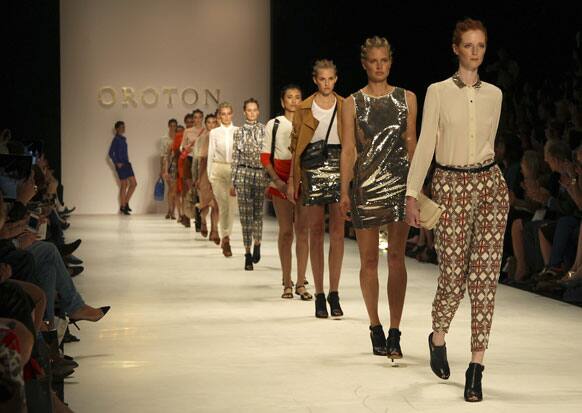 Models wearing designs from Oroton strut along the runway during Fashion Week Australia in Sydney.