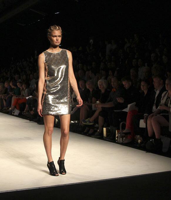 A model wearing designs from Oroton stands on the runway during Fashion Week Australia in Sydney.