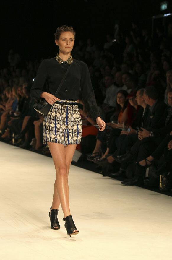 A model wearing a design from Oroton struts along the runway during Fashion Week Australia in Sydney.