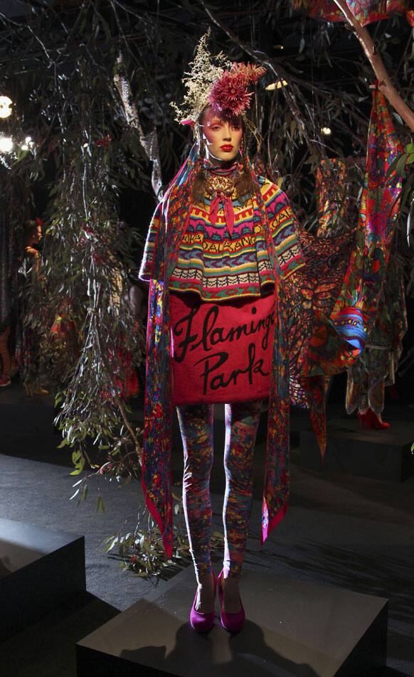 A model wearing designs by Jenny Lee stands in a display made of natural props including leaves and branches from native Australian trees, during Australian Fashion Week in Sydney.