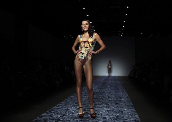 A model wearing a design from We Are Handsome stands at the end of the runway during Australian Fashion Week in Sydney.