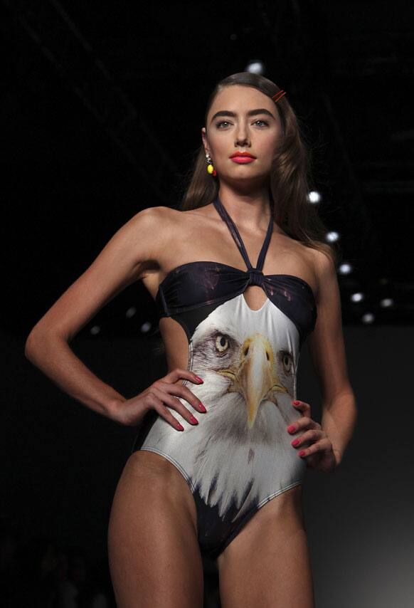 A model wearing a design from We Are Handsome stands at the end of the runway during Australian Fashion Week in Sydney.