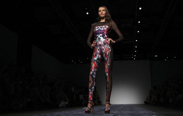 A model wearing a design from We Are Handsome stands at the end of the runway during Australian Fashion Week in Sydney.