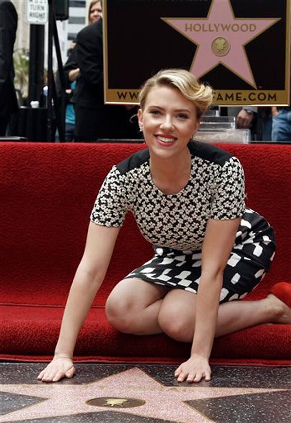 Scarlett Johansson poses for photographers after receiving a star on the Hollywood Walk of Fame in Los Angeles.