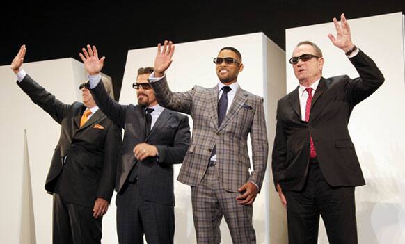 Director Barry Sonnenfeld, left, and cast members, from second left, Josh Brolin, Will Smith and Tommy Lee Jones wave during the Japan premiere of their film 