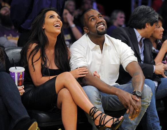 Kim Kardashian and Kanye West watch the Los Angeles Lakers play the Denver Nuggets in Game 7 in their first-round NBA basketball playoff series, in Los Angeles.