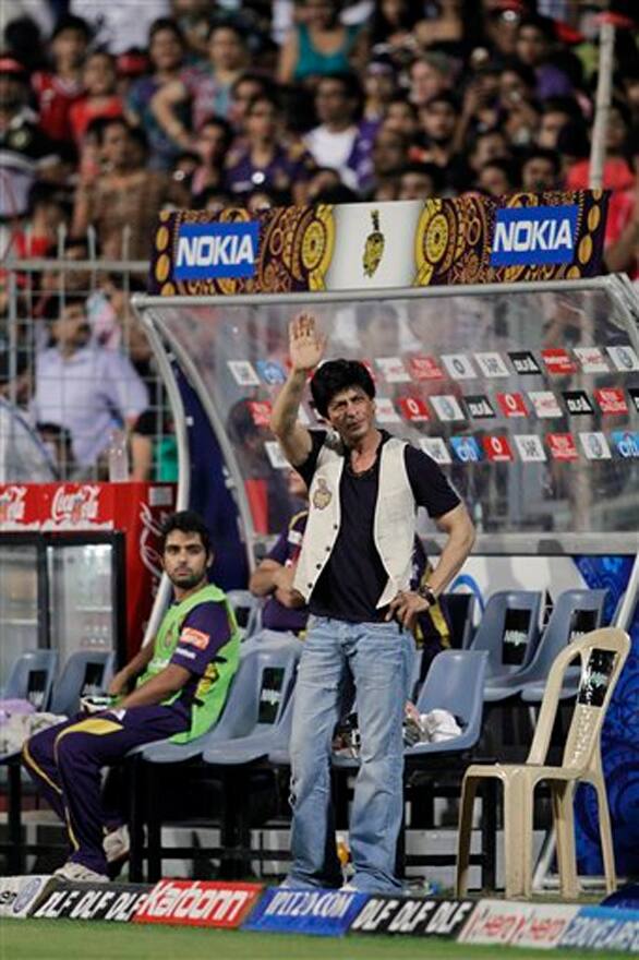 Shah Rukh Khan, co-owner of Kolkata Knight Riders', waves as he watches an Indian Premier League (IPL) cricket match against Chennai Super Kings in Kolkata.