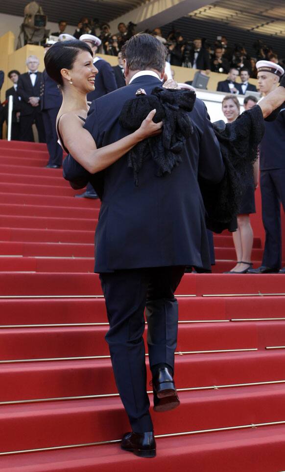 Actor Alec Baldwin carries Hilaria Thomas up the stairs for the opening ceremony and screening of Moonrise Kingdom at the 65th international film festival, in Cannes.