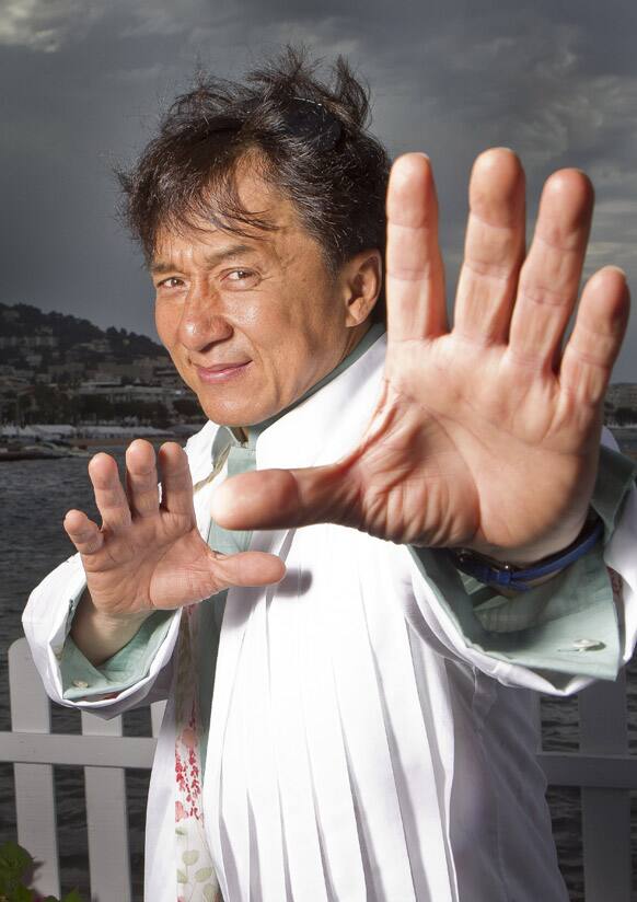 Jackie Chan poses for portraits at the American Pavilion during the 65th international film festival, in Cannes.