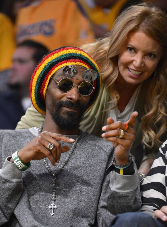 Rapper Snoop Dogg watch the Los Angeles Lakers play the Oklahoma City Thunder during the first half in Game 3 of an NBA basketball playoffs Western Conference semifinal in Los Angeles.