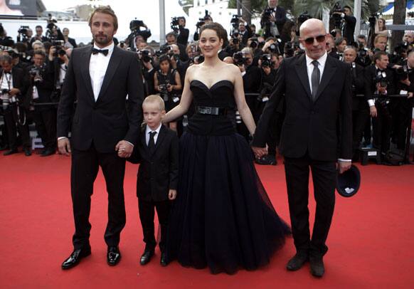 From left actors, Matthias Schoenaerts, Armand Verdure, Marion Cotillard and director Jacques Audiard arrive for the screening of Rust and Bone. Cotillard wore Dior.