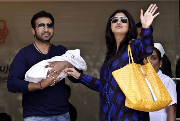 Shilpa Shetty and her husband Raj Kundra pose with their newborn baby boy outside a hospital in Mumbai.