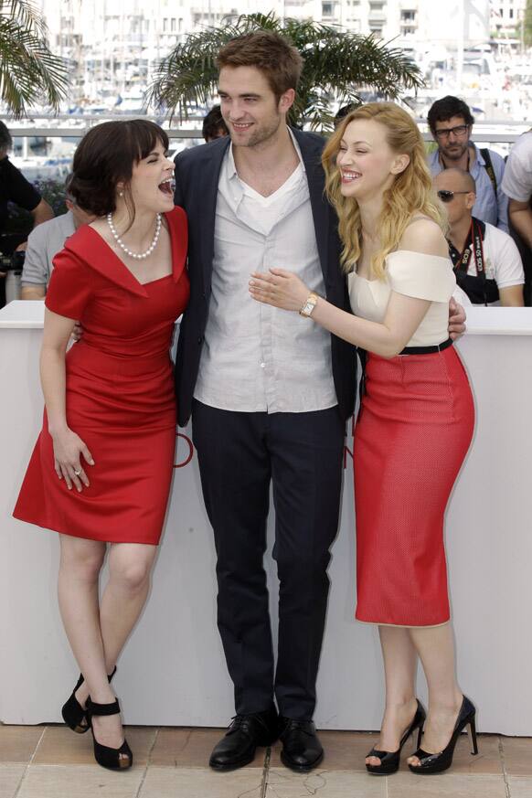 From left, actors Emily Hampshire, Robert Pattinson and Sarah Gadon pose during a photo call for Cosmopolis at the 65th international film festival, in Cannes.