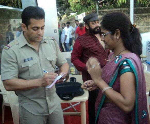 Salman Khan sign an autograph for a fan on the sets of 'Dabangg 2'.