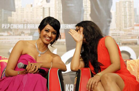 Pooja Kumar, left, and Andrea Jeremiah share a moment during a press conference for Bollywood actor and director Kamal Haasan’s latest movie 