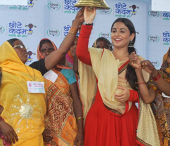 Vidya Balan and a women's self-help group take a pledge for promoting education by a campaign sponsored by Nihar Naturals in village Lusa, Uttar Pradesh.