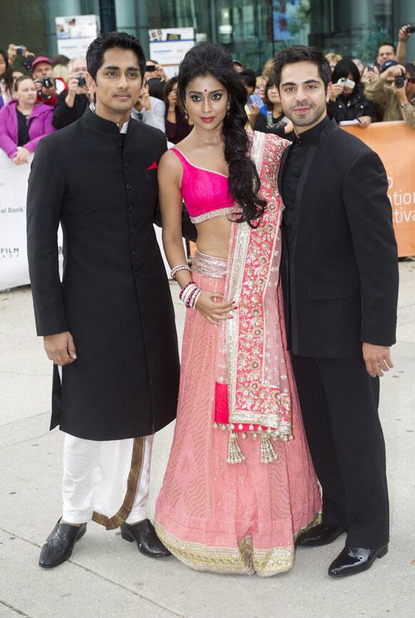 Actors Siddharh, left, Shriya Saran, centre, and Satya Bhabha, right, pose for photograph on he red carpet for the new movie 