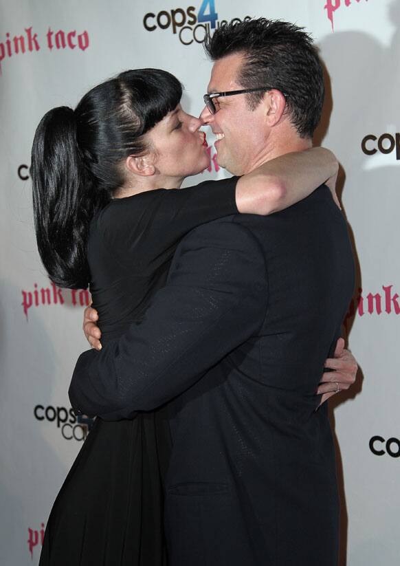 Pauley Perrette, left, kisses Thomas Arklie at the Cops 4 Causes 