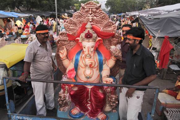 Hindu devotees transport an idol of God Ganesha on the eve of Ganesh Chaturthi festival in Ahmadabad.