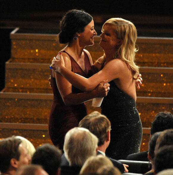 Amy Poehler, right, congratulates Julia Louis-Dreyfus as she walk onstage to accept the award for outstanding lead actress in a comedy series for 