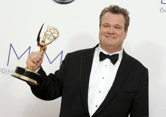 Eric Stonestreet poses backstage with his award for best supporting actor in a comedy series for 