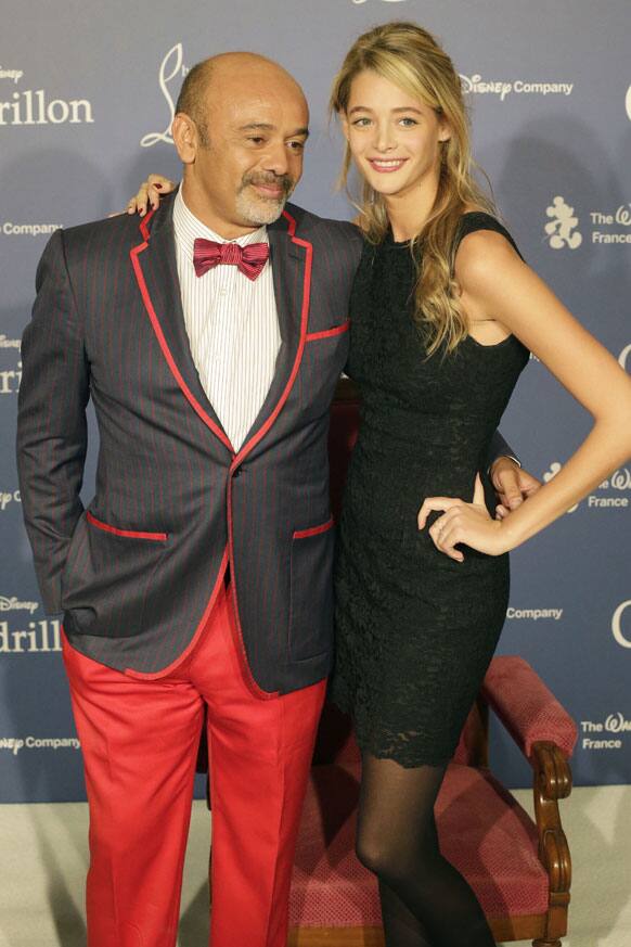 French designer Christian Louboutin and French model Claire Lang pose during the award ceremony of France's Disney Cinderella competition on the sideline of the Paris fashion week.