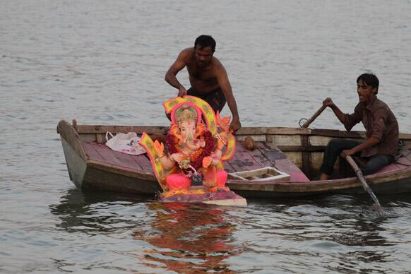 Boatmen immerse an idol of Hindu god Ganesha in the river Sabarmati during the Ganesh Chaturthi festival in Ahmadabad.