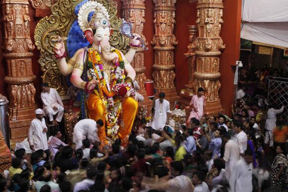 Devotees gather around an idol of Hindu God Ganesha in Mumbai.