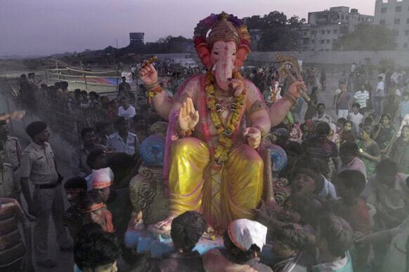 Devotees carry an idol of Hindu god Ganesha for immersion during Ganesh Chaturthi festival in Ahmadabad.