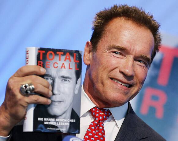 Former state governor of California, Arnold Schwarzenegger displays his book 