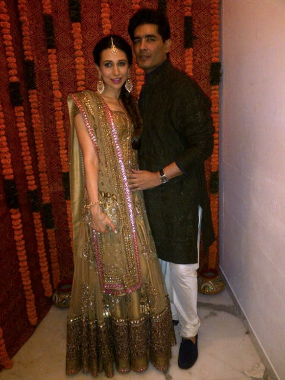 Bride's sister, Karisma Kapoor poses with Manish Malhotra at Kareena and Saif's sangeet ceremony.