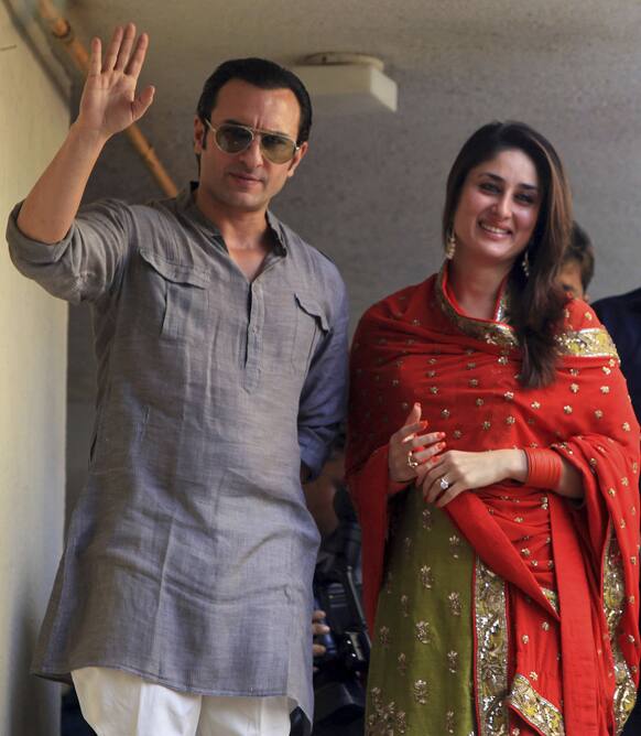 Bollywood stars Saif Ali Khan, left, and Kareena Kapoor step out on a balcony to greet waiting fans after getting married in Mumbai.