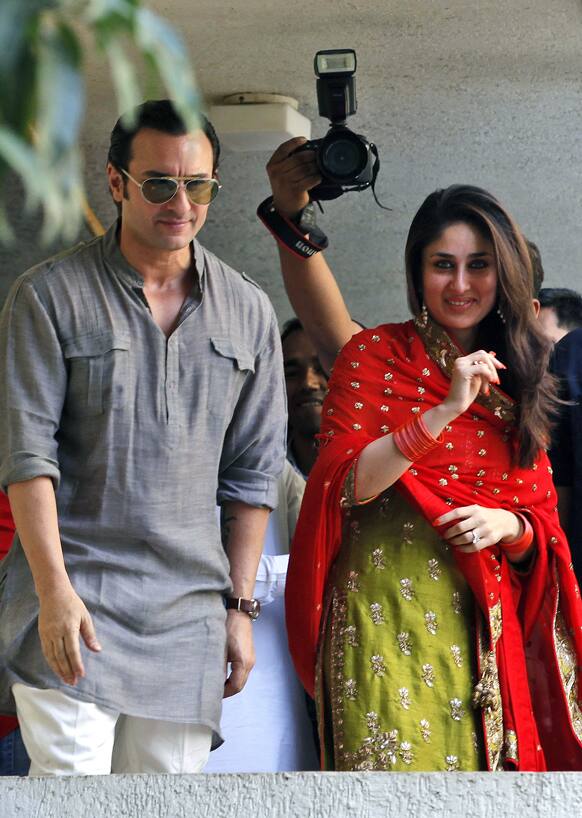 Bollywood stars Saif Ali Khan, left, and Kareena Kapoor step out on a balcony to greet waiting fans after getting married in Mumbai.