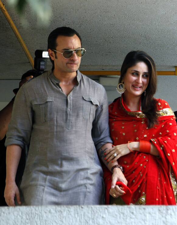 Bollywood stars Saif Ali Khan, left, and Kareena Kapoor step out on a balcony to greet waiting fans after getting married in Mumbai.