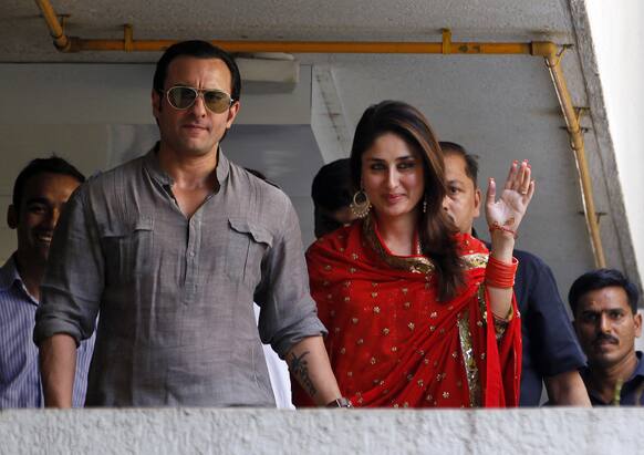 Bollywood stars Saif Ali Khan, left, and Kareena Kapoor step out on a balcony to greet waiting fans after getting married in Mumbai.