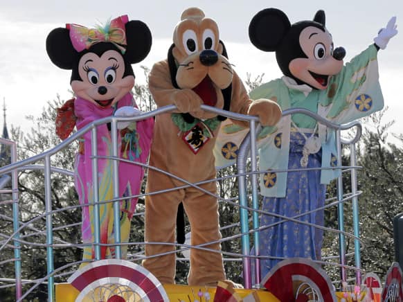 Clad-in kimono, Mickey Mouse, right, Minnie Mouse, left, and Pluto entertain visitors to the Tokyo Disneyland during the New Year celebrations at the amusement park in Urayasu, east of Tokyo.