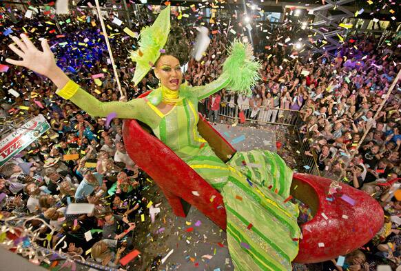 Gary Marion, a female impersonator known as Sushi, hangs in an oversized replica of a women's red high heel over Duval Street, at the Bourbon Street Pub Complex in Key West, Fla.