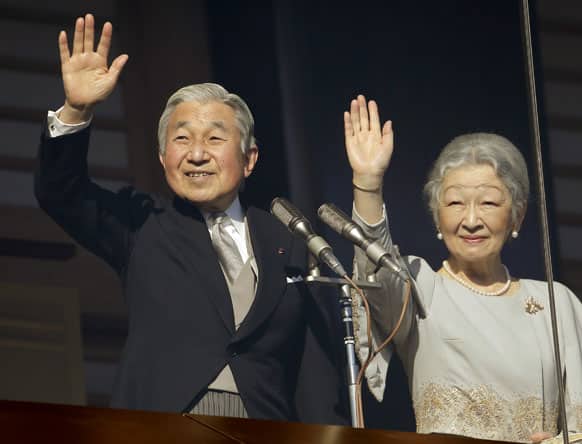 Emperor Akihito and Empress Michiko show at a balcony as they acknowledge to well-wishers for the new year's celebrations at the Imperial Palace in Tokyo.