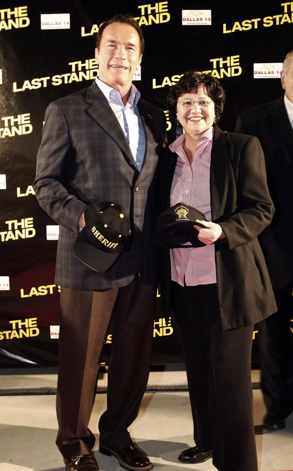 Arnold Schwarzenegger and Dallas County Sheriff Lupe Valdez pose with Sheriff caps during the red carpet premiere of