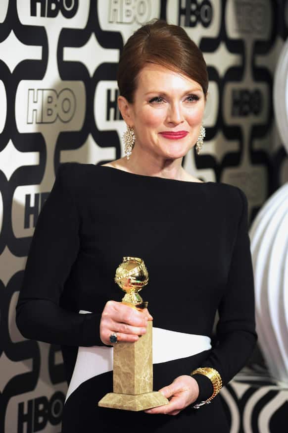 Actress Julianne Moore poses with her award for best actress in a miniseries for
