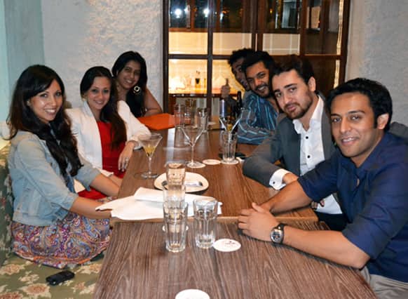 Bollywood actor Imran Khan (in a grey suit) is clicked having a quiet dinner to celebrate his birthday with his wife Avantika (in a red dress and a white blazer) and a few close friends at Cheval in Kala Ghoda, Mumbai.