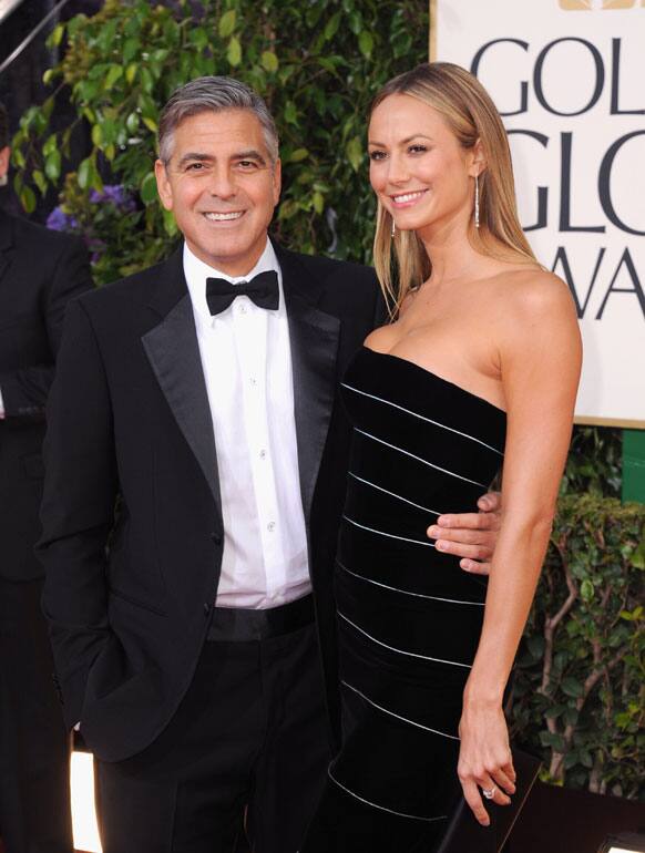 George Clooney, left, and Stacy Keibler arrive at the 70th Annual Golden Globe Awards at the Beverly Hilton Hotel.
