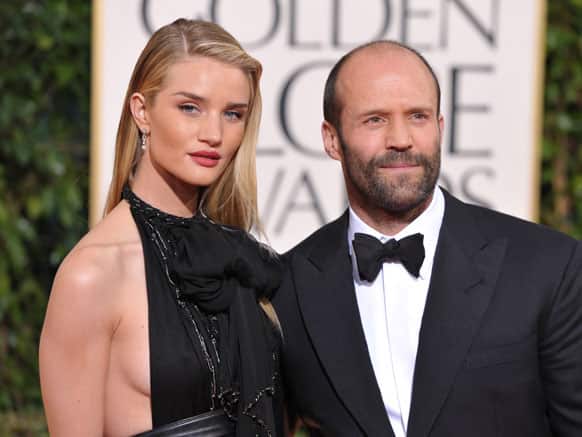 Actors Rosie Huntington-Whiteley, left, and Jason Statham arrive at the 70th Annual Golden Globe Awards at the Beverly Hilton Hotel.