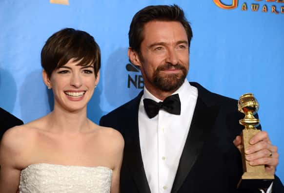Actors Anne Hathaway, left, and Hugh Jackman pose with the award for best motion picture comedy or musical for