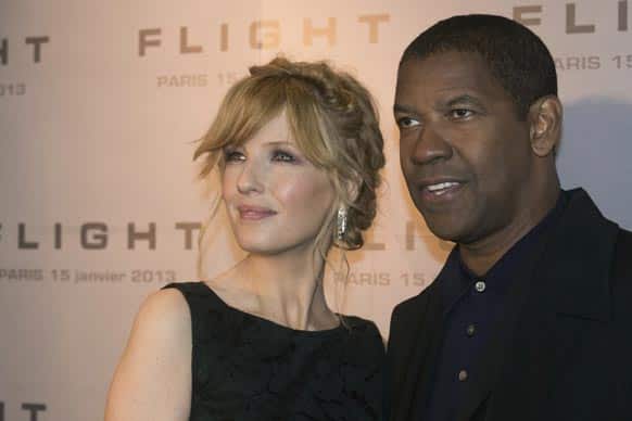 British actress Kelly Reilly, left, and American actor Denzel Washington, right, pose as they arrive for the French Premiere of