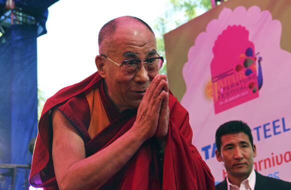 The Dalai Lama greets the audience as he arrives to speak on the opening day of India's Jaipur Literature Festival in Jaipur.